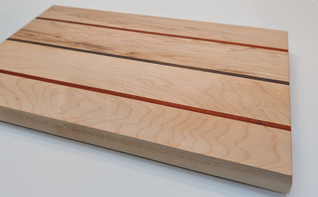 The Triad. Maple Serving board with Padauk and walnut inlay.